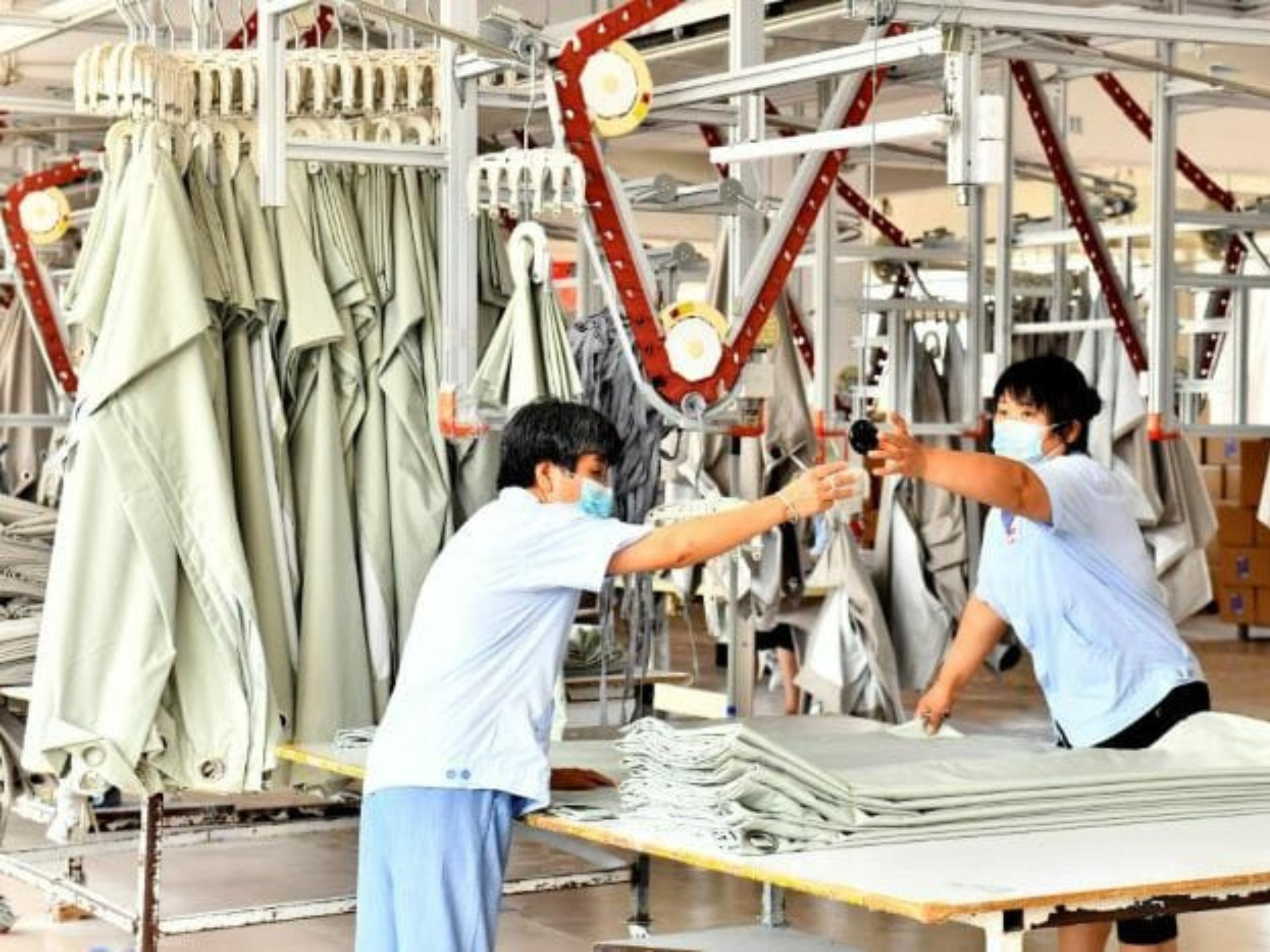 Staffs are seen working together in China's curtain manufacturing factory.
Image Source: Business Today